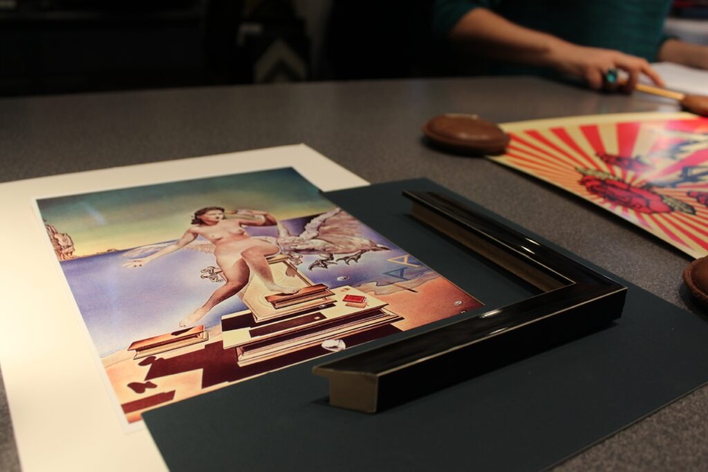 custom framing process with the art piece, frame, and board
